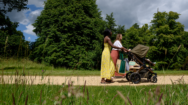 Parents walk with their children around Stowe Gardens